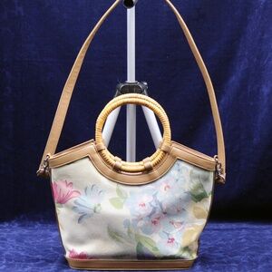 Fossil Floral and Rattan handled, adjustable strap bag.